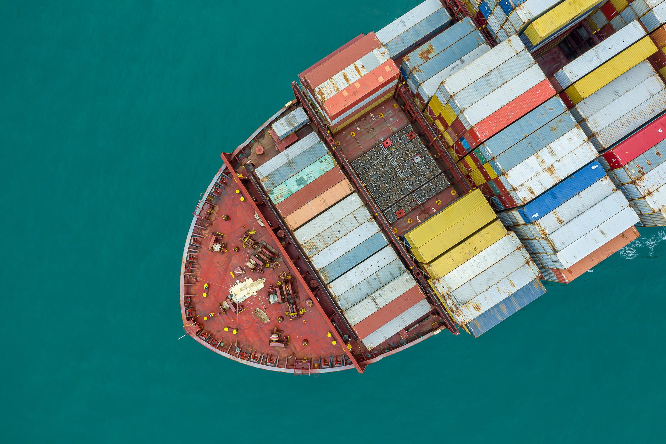 Aerial top view of cargo ship carrying container for import export goods  to customer,concept logistic and supply chain